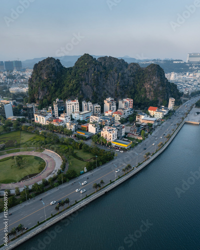 Aerial view of beautiful cityscape with mountains, waterfront, and modern buildings, Ha Long, Quang Ninh, Vietnam. photo
