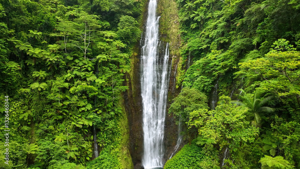 Aerial view of a breathtaking tropical waterfall surrounded by lush greenery and forest, Tuamasaga, Samoa. Aerial view of a breathtaking tropical waterfall surrounded by lush greenery and forest, Tuamasaga, Samoa.
