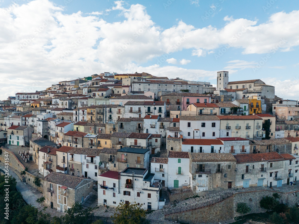 Aerial view of the picturesque medieval town with stone buildings and charming rooftops on a hill, Rotondella, Matera, Italy. Aerial view of the picturesque medieval town with stone buildings and charming rooftops on a hill, Rotondella, Matera, Italy.