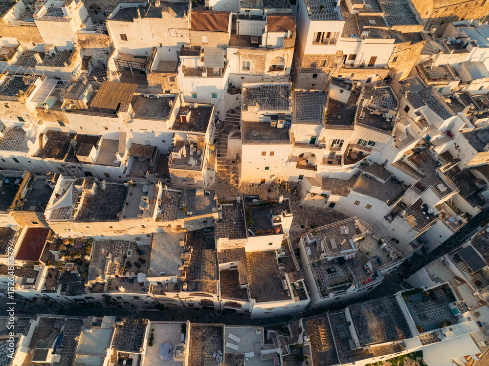 Aerial view of beautiful historic old town with medieval architecture and scenic rooftops, Ostuni, Brindisi, Italy. Aerial view of beautiful historic old town with medieval architecture and scenic rooftops, Ostuni, Brindisi, Italy.