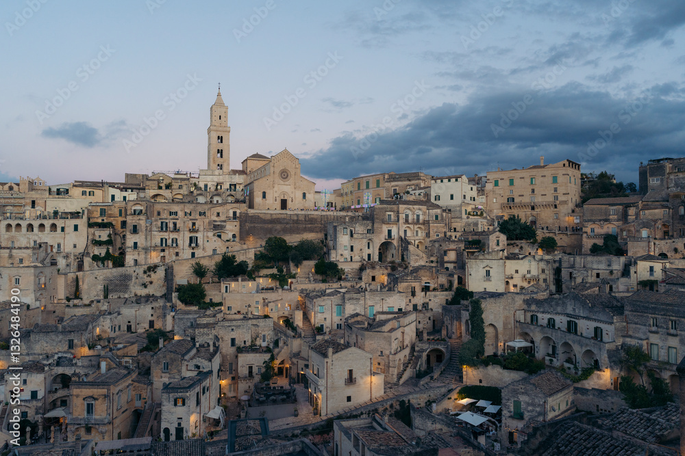 Aerial view of the historic Duomo di Matera and medieval buildings in the old town during sunset, Matera, Basilicata, Italy. Aerial view of the historic Duomo di Matera and medieval buildings in the old town during sunset, Matera, Basilicata, Italy.