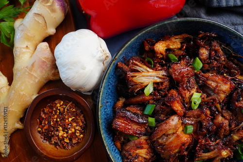 Cooking Chinese Sticky Pork for dinner. Using a pork belly cut into pieces and adding a spicy marinade to make a delicious Asian meal.