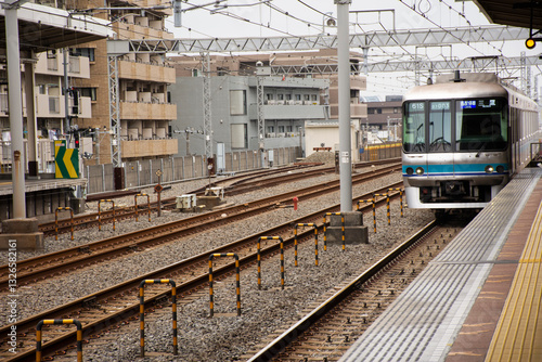 Japanese people and foreign traveler passengers wait and walking up and down journey with MRT Tozai Line trains go to Ginza at Kasai Station in Tokyo, Japan
