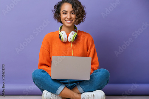 Woman with headphones and laptop smiling