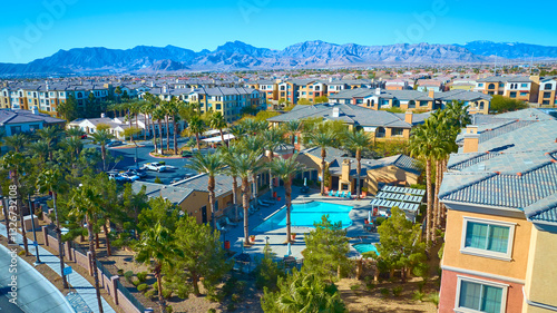Aerial of Desert Suburban Community with Pool and Mountain Backdrop
