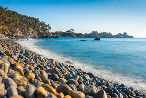 Beach in Korea with round rocks and a long exposure water  tide at sunrise