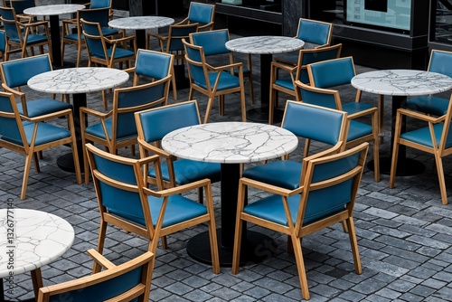 outdoor café or restaurant seating area with multiple round tables and chairs arranged in an organized pattern on a stone-paved ground cafetería o restaurante al aire libre con varias mesas redondas photo