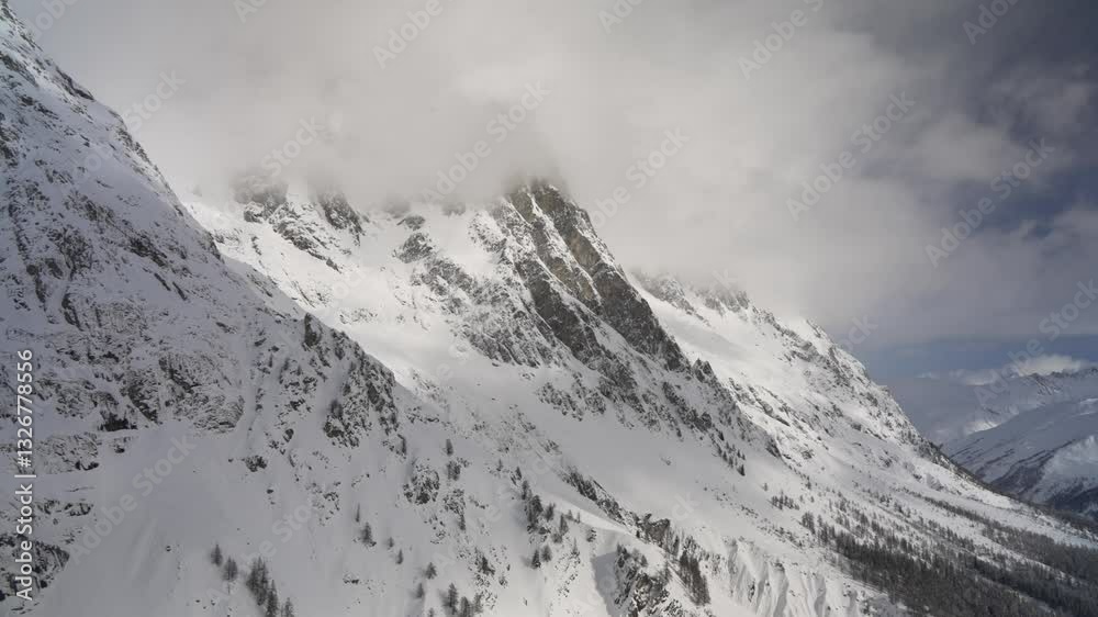 View of mountain peaks on the Italian and French border on a sunny day in winter, Courmayeur, Aosta Valley, Italian Alps, Italy View of mountain peaks on the Italian and French border on a sunny day in winter, Courmayeur, Aosta Valley, Italian Alps, Italy