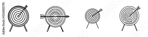 Archery targets with arrows striking at different positions in outdoor range setting during daylight hours