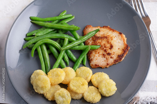 boneless pork chop with green beans and potato crowns