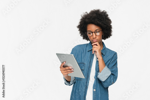 Wallpaper Mural Internet browsing. Digital network. Gadget technology. Pensive thinking African woman using holding PC digital tablet pad standing isolated on white background. Torontodigital.ca