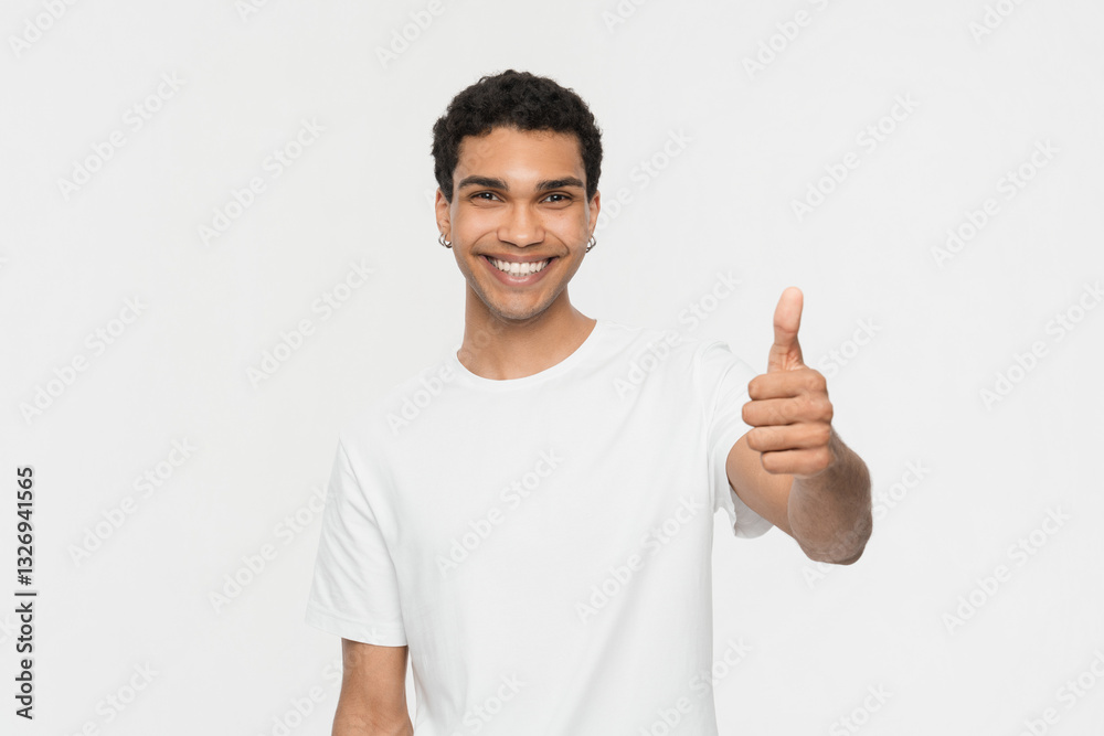 Cheerful African-American guy in casual shirt showing thumb up isolated on white background wall studio portrait. Smiling man showing approval gesture looking at camera, likes it Cheerful African-American guy in casual shirt showing thumb up isolated on white background wall studio portrait. Smiling man showing approval gesture looking at camera, likes it