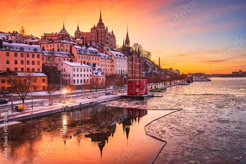 Stockholm, Sweden. Sunset with  Mariaberget snow dusted downtown and frozen Lake Malaren.