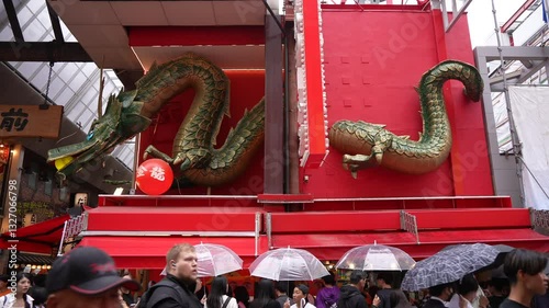 View of people, shops and restaurants in busy Dotonbori, vibrant entertainment district near the river, Osaka, Honshu, Japan