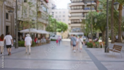 Wallpaper Mural Blurred outdoor street scene with buildings, trees, people walking, and outdoor cafes in a sunny urban setting Torontodigital.ca