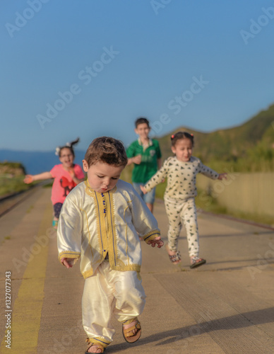 Eid clothes, Happy Muslim children in traditional dress on Eid day, A little boys playing and having fun on Eid day with new clothes, Arab child in traditional Moroccan dress in Algeria, North Africa.