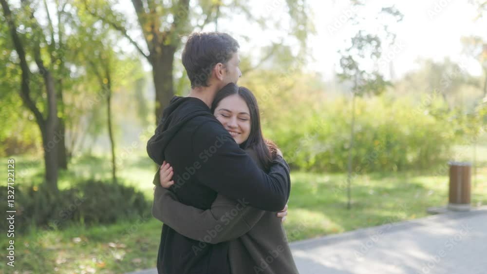 Love and Laughter as Couple Embraces in Autumn Park Setting Love and Laughter as Couple Embraces in Autumn Park Setting