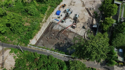 Aerial view of workers laying concrete slab