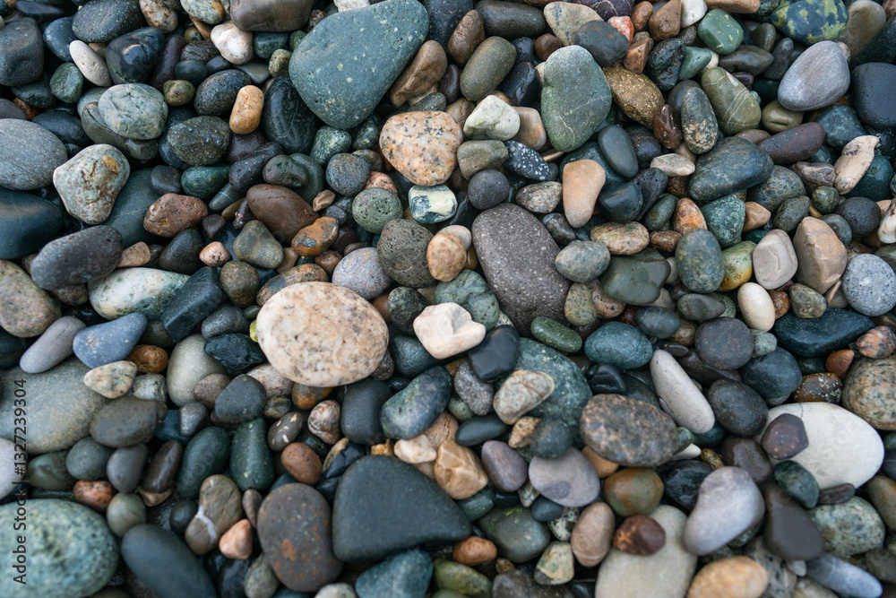 Texture of wet small pebbles of rocks on the beach Texture of wet small pebbles of rocks on the beach