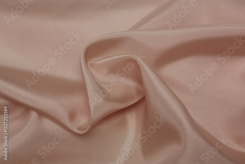 Apricot pink folded fabric background or texture