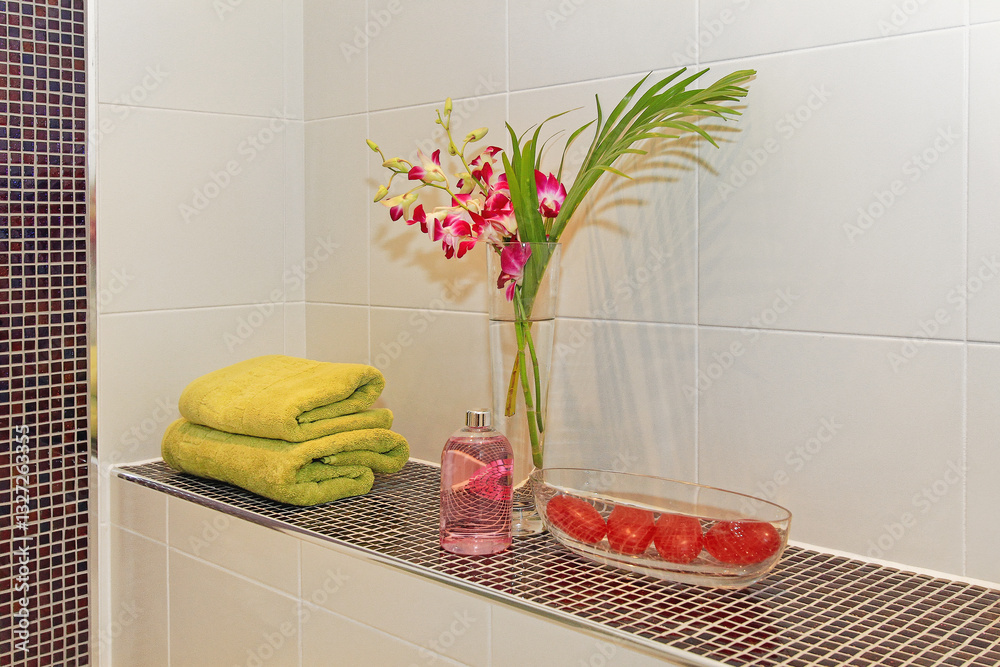 Clean Towels Flowers in Vase Soaps in Glass Bowl Decoration at Bathroom Shelf