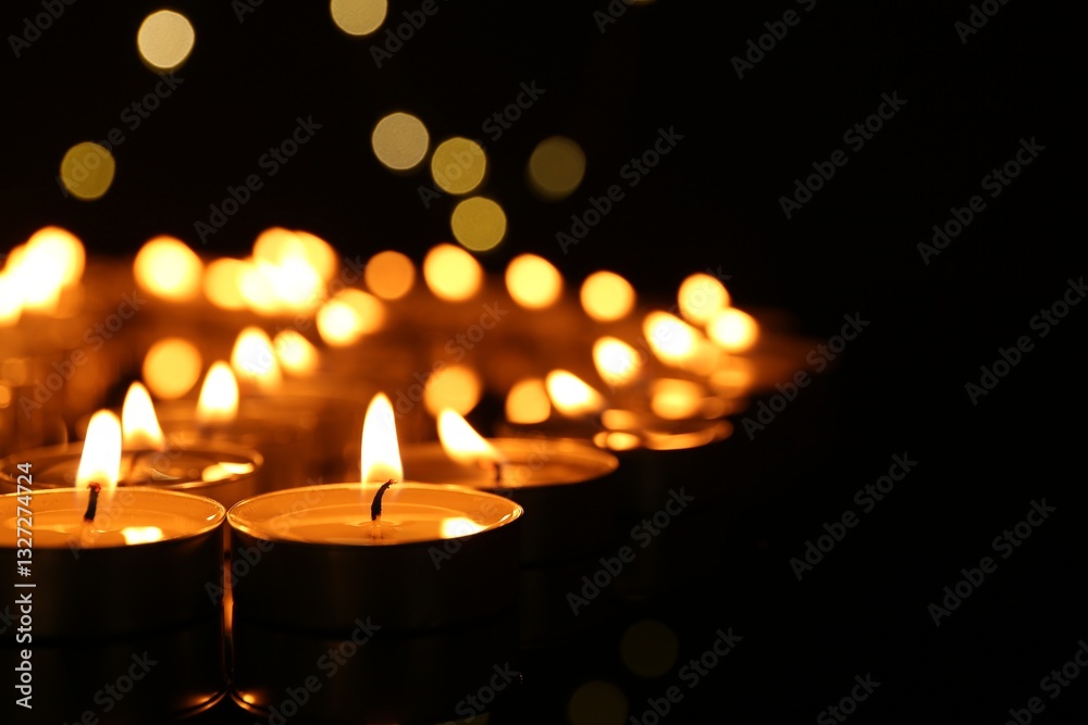 Many burning candles in darkness, closeup. Space for text Many burning candles in darkness, closeup. Space for text