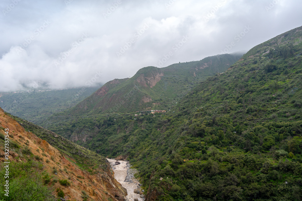 Colca Canyon and river in the mist and clouds, Peru