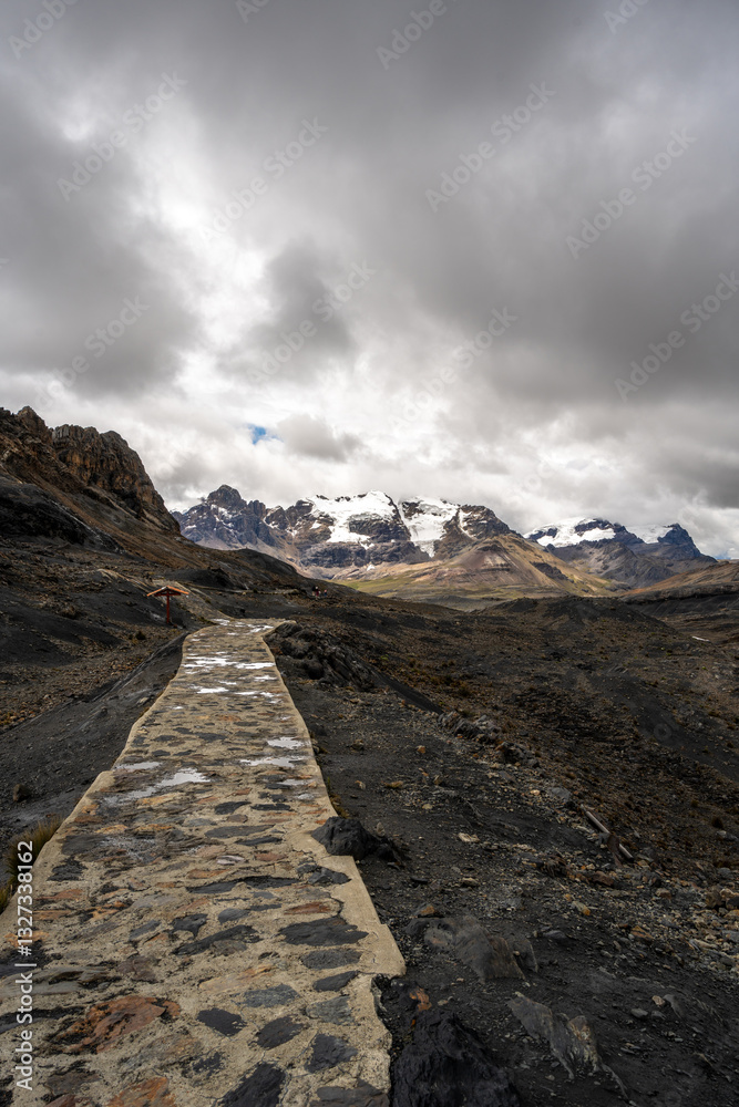 Stone trail leading to Pastoruri Glacier, Huaraz, Peru, amidst rugged mountains