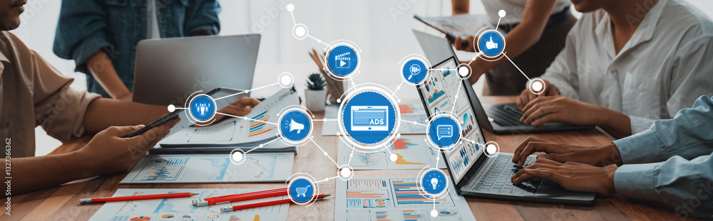 A modern workspace showcasing collaboration among team members using laptops and smartphones, engaging in data analysis and interactive discussions, surrounded by digital elements. Amity A modern workspace showcasing collaboration among team members using laptops and smartphones, engaging in data analysis and interactive discussions, surrounded by digital elements. Amity