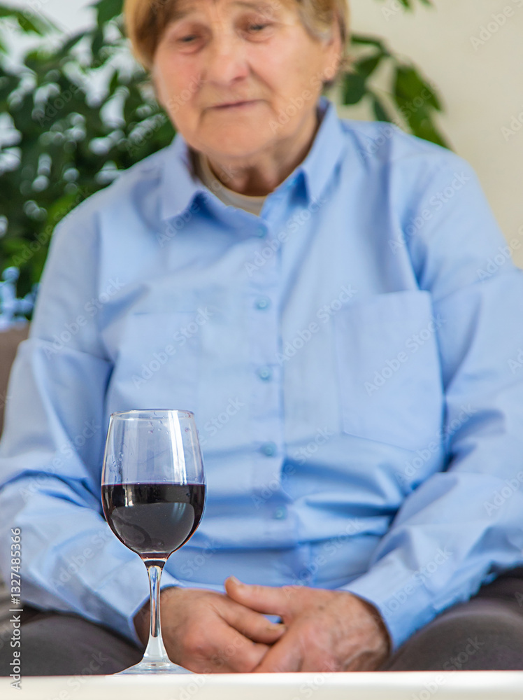 Old woman drinking wine. Selective focus. Old woman drinking wine. Selective focus.
