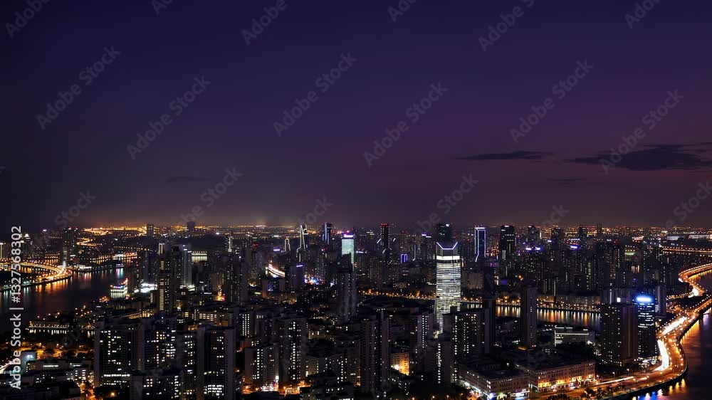 Transition from dusk to night over illuminated city skyline with vibrant urban lights Transition from dusk to night over illuminated city skyline with vibrant urban lights