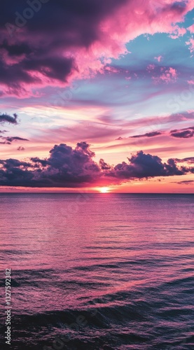 beautiful sunset with pink and purple clouds on the sea, ideal for an mobile phone wallpaper, phone background, or screen
