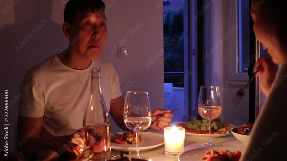 Couple enjoying romantic candlelit dinner at home Couple enjoying romantic candlelit dinner at home