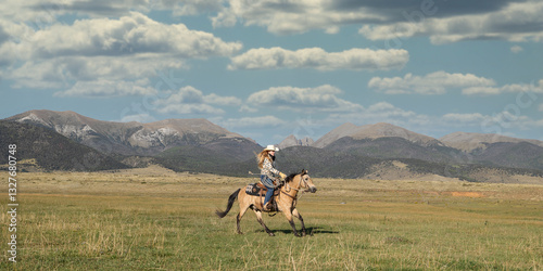 Colorado Cowgirl Riding Buckskin Quarter Horse in Mountains