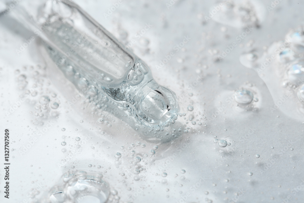 Pipette with cosmetic serum on light background, closeup Pipette with cosmetic serum on light background, closeup