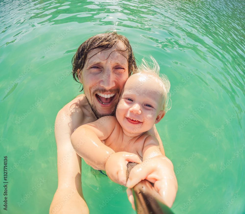 Toddler and father joyfully swimming in the turquoise Caribbean Sea. Family bonding, seaside fun, and tropical vacation concept
