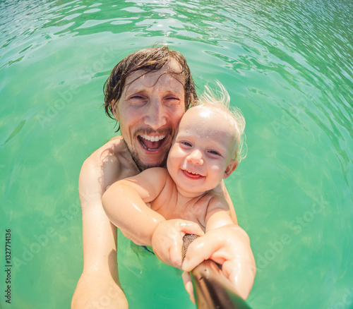 Obraz na płótnie Toddler and father joyfully swimming in the turquoise Caribbean Sea. Family bonding, seaside fun, and tropical vacation concept w salonie