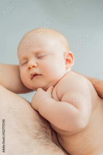 A baby peacefully falls asleep in his father's arms, skin-to-skin. A heartwarming and intimate moment of love, bonding, and parenthood, showcasing the deep connection between father and child