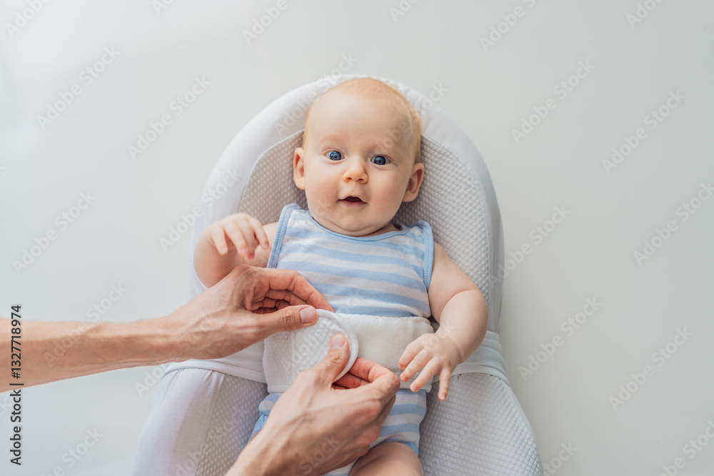 Adorable 3-month-old baby lying safely in a cozy infant cocoon secured with a special safety belt. Comfortable and protective design for newborn care. Parenting, safety, and baby comfort concept