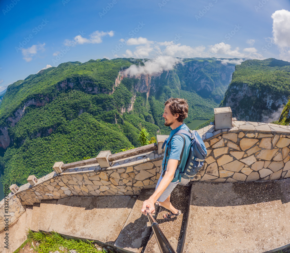 Male tourist exploring Sumidero Canyon National Park, Mexico. Adventurous traveler enjoying breathtaking views of cliffs and river in this iconic natural landmark. Concept of nature, exploration, and