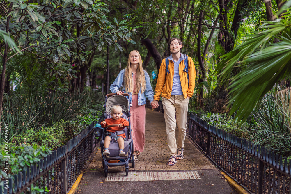 A married couple and their son in a stroller exploring lush streets of Condesa, Mexico City. Family adventure in a vibrant urban oasis. Travel, family bonding, and urban greenery concept in Latin