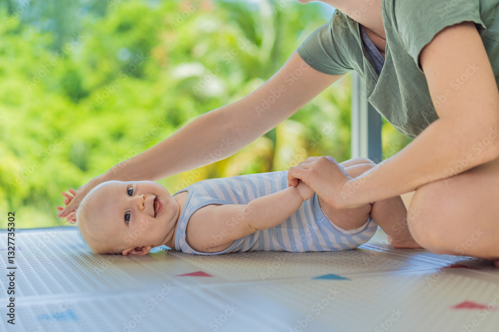 A mother practices baby gymnastics with her 3-month-old on a soft children's play mat. A joyful and nurturing moment focused on bonding, development, and care. Early childhood, fitness, and parenting