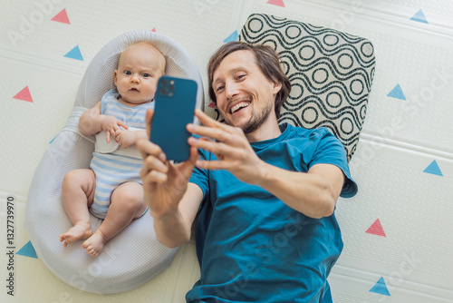 A 3-month-old baby lies safely in a cozy infant cocoon, secured with a special safety belt, while their father lies beside them during a video call. Modern parenting, bonding, and technology concept
