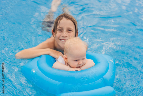 Obraz na płótnie An older brother swims in a pool alongside his baby sibling, who is safely seated in an inflatable float. Joyful family moment full of laughter, bonding, and summer fun. Childhood, care, and sibling w salonie