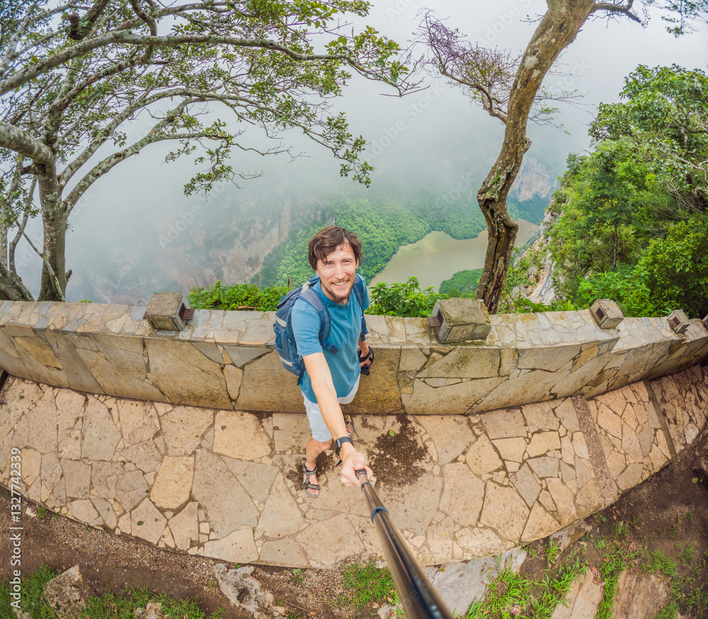 Male tourist exploring Sumidero Canyon National Park, Mexico. Adventurous traveler enjoying breathtaking views of cliffs and river in this iconic natural landmark. Concept of nature, exploration, and