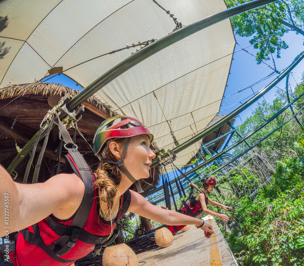 Mother and son tourists flying on a zipline over a tropical park. Thrilling family adventure surrounded by nature, ideal for eco-tourism and bonding experiences. Travel, outdoor fun, and family