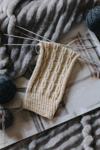Hand knitted socks with needles and yarn ball. Concept for handmade and hygge slow life.