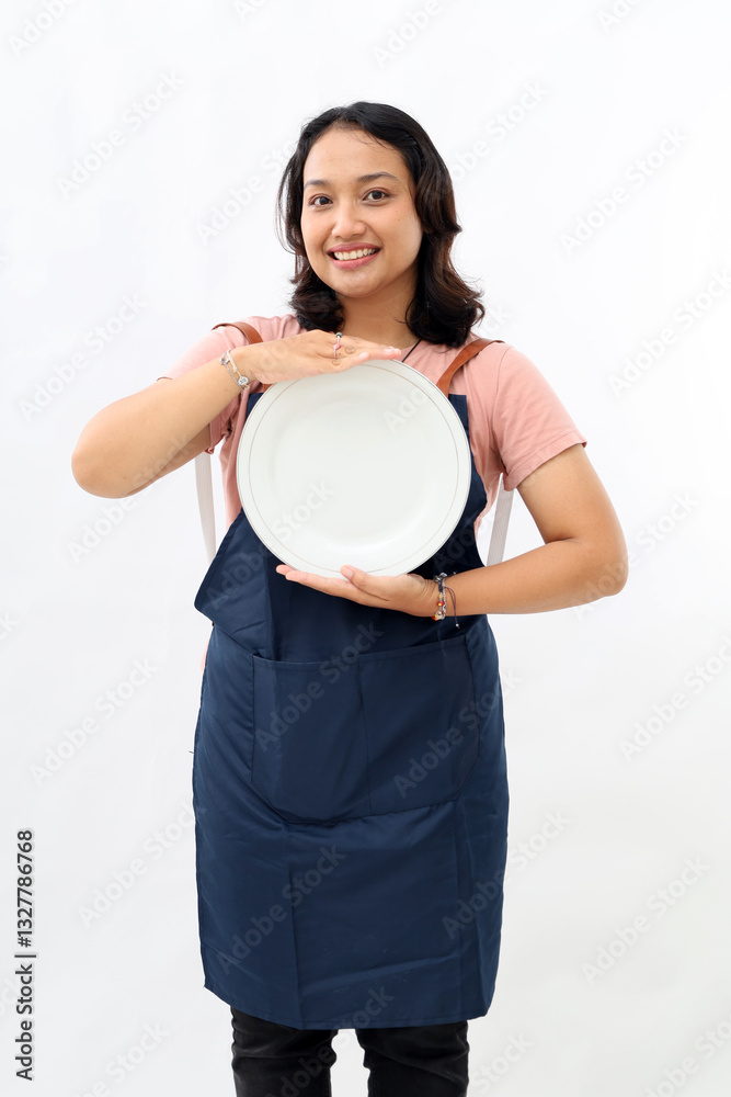 Cooking, culinary and people concept, happy smiling asian woman in apron holding clean empty plate over white background Cooking, culinary and people concept, happy smiling asian woman in apron holding clean empty plate over white background