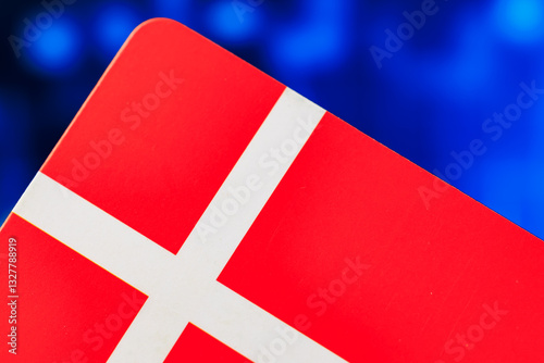 Close-up of danish flag with vibrant red and white colors on blue background