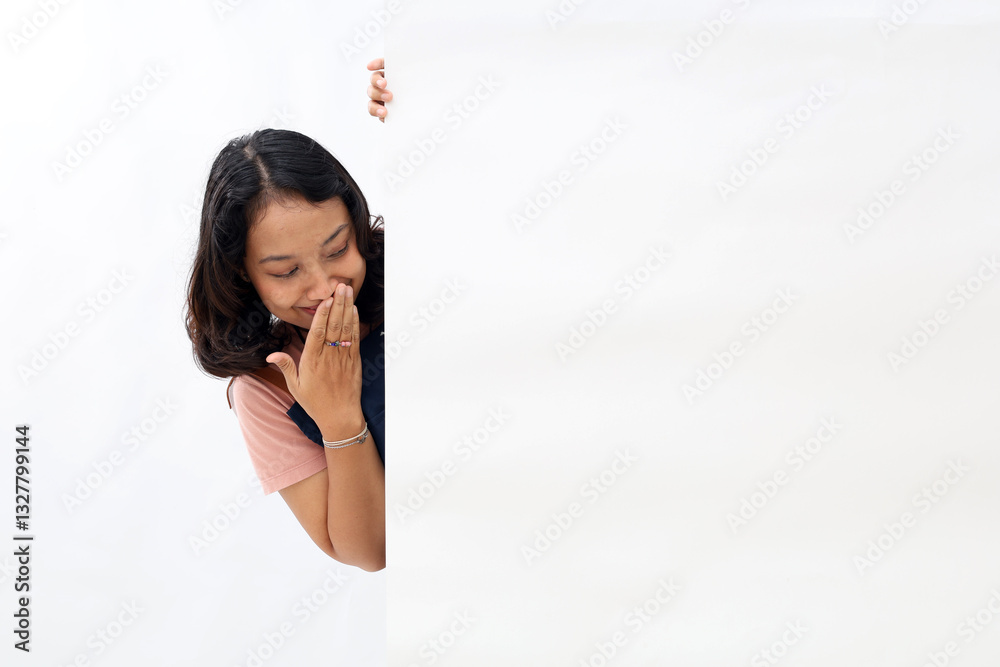 Wow surprised asian woman in blue apron peeking behind the wall
